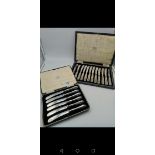 A boxed set of 12 silver handled butler knives, together with a boxed set of 6 six silver handled