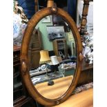 An art deco oak framed bevel edge mirror. Measures 75x49cm