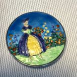 A Birmingham silver and enamel lady with flowers brooch, Makers F.J.M & Co dated 1947. Measures 4.