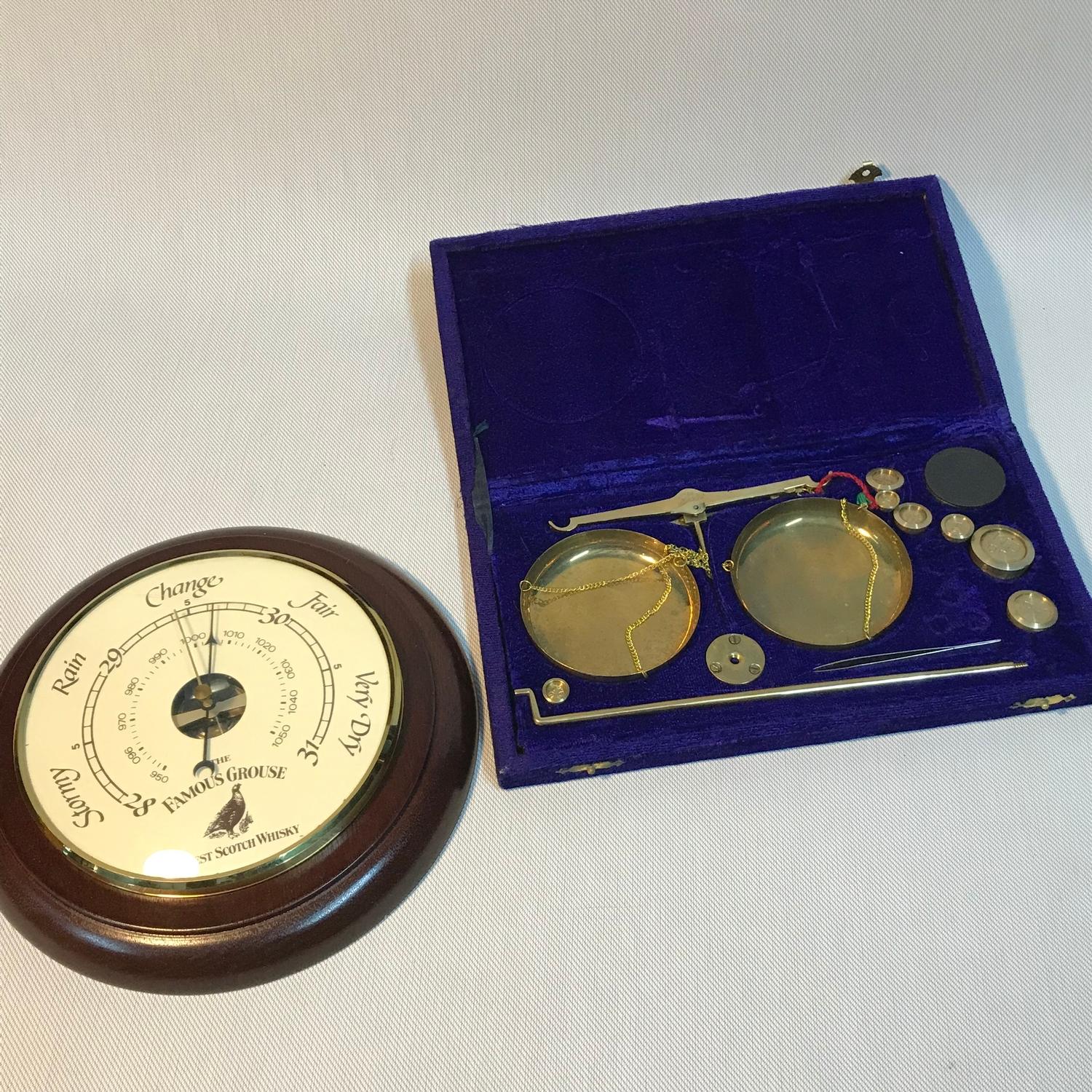 A Famous grouse advertising barometer together with a boxed set of weighing scales with weights.