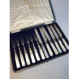 A Set of 12 Sheffield silver collard and mother of pearl handle fork & knife set. Makers John