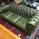 A Green leather Chesterfield Three seat settee.