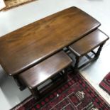 A Vintage Ercol elm wood side table with two pull out smaller tables. Large table measures