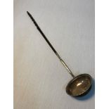 A Georgian London silver ladle with horn handle. Dated 1774. Measures 36cm in length