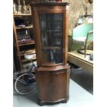 A Reproduction serpentine front corner display cabinet.