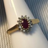 A Birmingham 18ct gold ladies diamond cluster and single ruby stone ring, Ring size N, Weighs 3,
