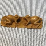 A Japanese meiji period netsuke detailing two frogs facing each other. Signed to the base.