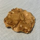 A Japanese Meiji period carved netsuke detailing a lily pad with two frogs. Signed. Measures 4cm