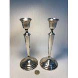 A Pair of Birmingham silver candle sticks made by William Aitken. Measures 23cm in height