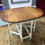 A Solid light oak topped, drop end dining table. Painted white base leg supports. Fully extended