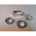 A lot of three silver hallmarked napkin rings together with a silver collared glass pot