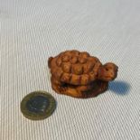 A Small Japanese hand carved tortoise netsuke figure. Signed to the base, Measures 5.3cm in length.