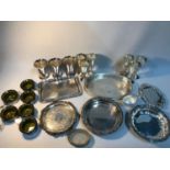 A Collection of silver plated and E.P. Serving trays, cups, wine goblets and pudding serving dishes.