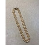 A Vintage two strand pearl necklace fitted with a 9ct gold clasp.