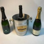 A Vintage Champagne Mercier ice bucket together with three bottles of Champagne