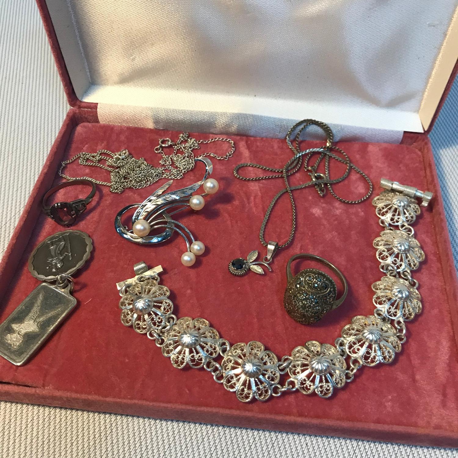 A Selection of silver jewellery which includes Egyptian silver floral design bracelet, silver and
