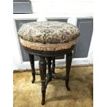 A Regency rosewood swivel top rise and fall piano stool, Supported on reed legs and hoof feet. Has a