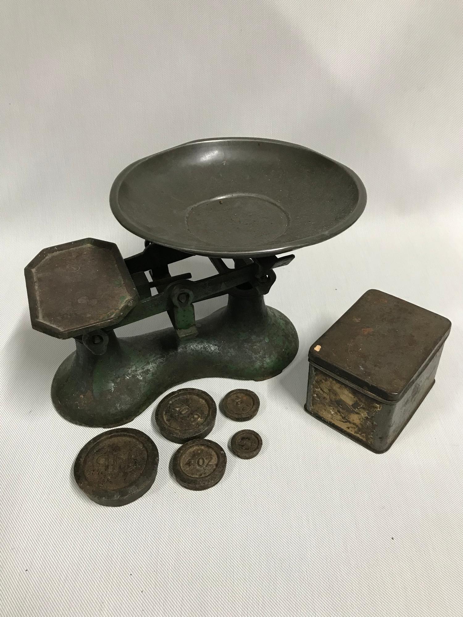 A Vintage set of kitchen scales with weight, still showing signs of original green paint.