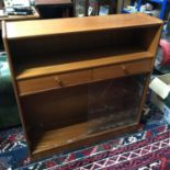 A Mid century teak two drawer, bookcase cabinet, Has two glass sliding doors to the base. Measures