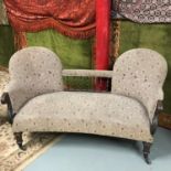 A Victorian two seat parlour settee. Supported on 4 mahogany turned legs and original brass castor