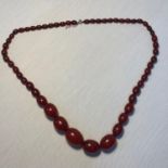 A Early 1900's cherry amber graduating bead necklace,Measures 36.5cm drop. Weighs 73.10grams