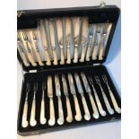 Antique set of forks and knives all set with mother of pearl handles. Comes with a box. 24 pieces in