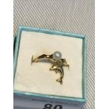 A Ladies 10ct gold ring set with a single pearl together with an 18ct gold dolphin pendant.
