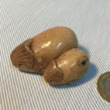 An early 1900's hand carved Japanese Netsuke figure of mother and baby whale. Signed by the