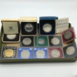 A Lot of vintage cased crowns which includes three Royal Mint silver proof coins.