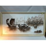 A Large oil painting on canvas depicting junk boats. Signed by the artist. Frame measures 69x130cm