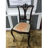 An Edwardian chair designed with a Pierced Splat back and supported on Cabriole legs.