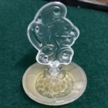 A Vintage Lalique art nouveau perfume bottle detailed with a nude lady stopper. Measures 6.5cm in