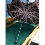 A Ladies vintage Umbrella designed with a white metal and jewel handle. Showing floral design to the