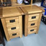 A Pair of Solid light oak contemporary three drawer bedside cabinets. Measure 70x45x40cm