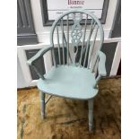 A 19th century Windsor wheel back arm chair. Painted with a pale blue paint.