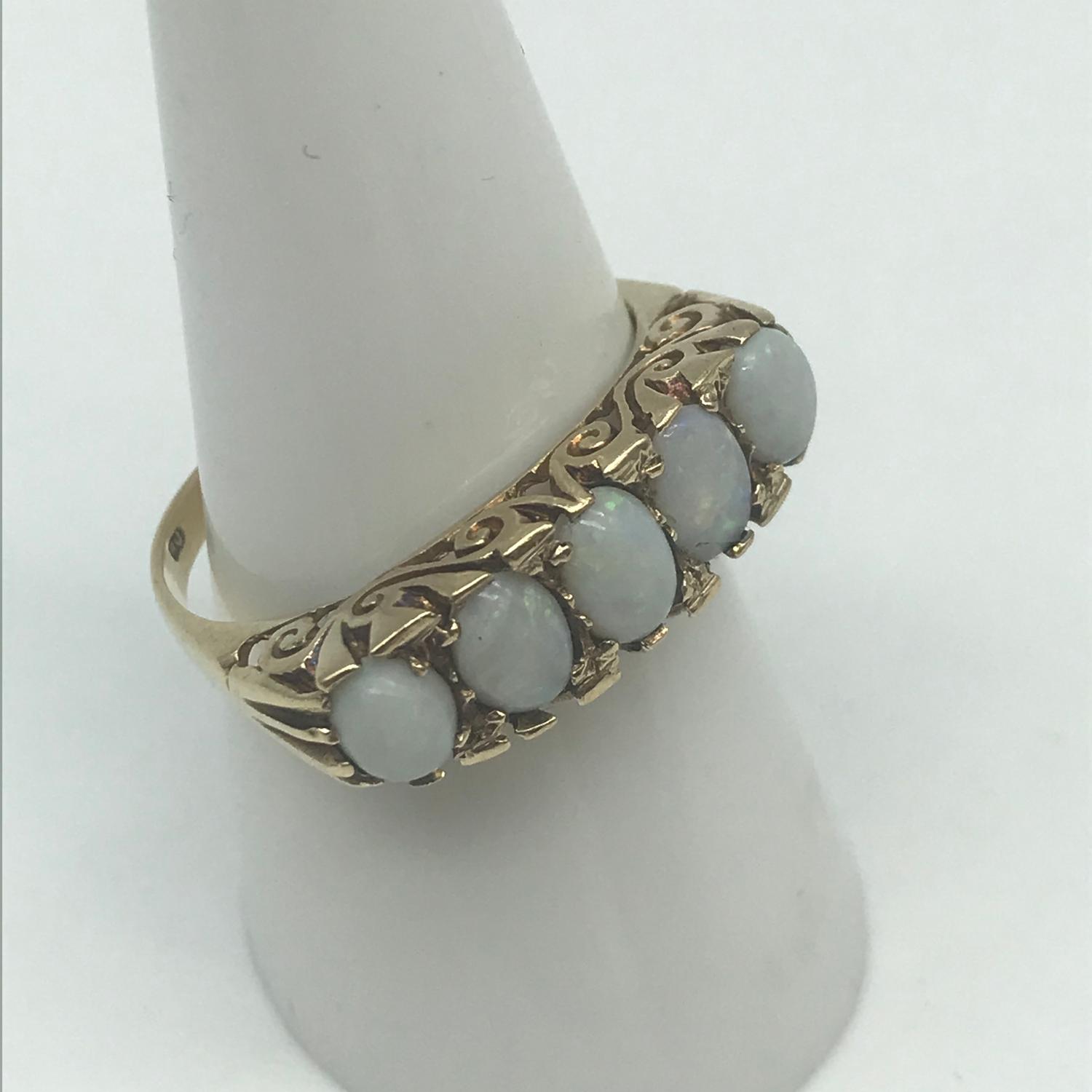 A 9ct gold ladies large set opal set ring, Consists of 5 large opal stones, Ring size Q, Weighs 3.