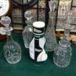 A Lot of 4 cut crystal decanters together with a McGibbon's golf bag decanter.