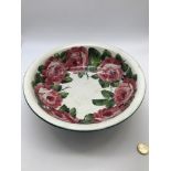 A Wemyss Ware bowl designed with hand painted Cabbage roses. Has impressed and hand painted markings