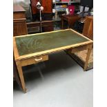 A Retro Invictus two drawer desk with green leather top.