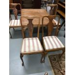 A Mid 20th century extending table with 4 chairs.