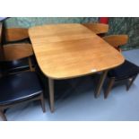 A Mid century teak Nathan Furniture extending table with 4 matching chairs.