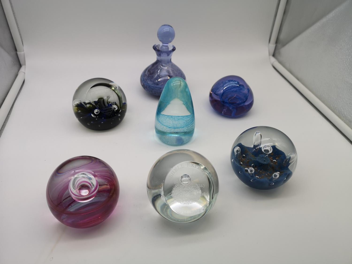 A collection of five Caithness paperweights together with one other paperweight & a perfume
