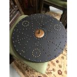 A Reproduction battle shield made from leather and stud designs