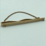 A 9ct gold front and back tie clip. Weighs 7.83grams