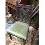 A Victorian highly carved Gothic and green man carved parlour/ Library chair. Designed with two