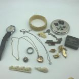 A Collection of vintage costume jewellery which includes Miracle pendant, Stratton compact &