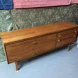 A Mid century teak pedestal sideboard produced by Nathan Furniture. Measures 76x183x45.5cm