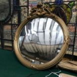 Antique gilt framed convex mirror. Finished with a moulded floral design top. Measures 47cm in