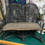 A Childs Victorian wicker weaved and bamboo double arm chair.