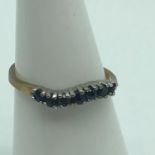 A 9ct gold ladies ring set with 7 Sapphires. Ring size J 1/2. Weighs 1.27grams